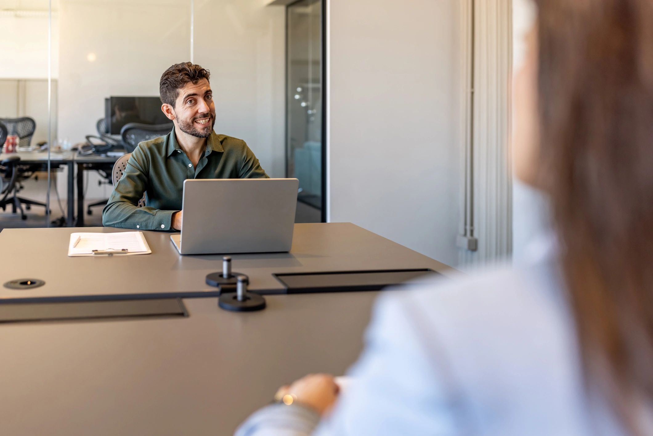 Professional interview conversation across a conference table
